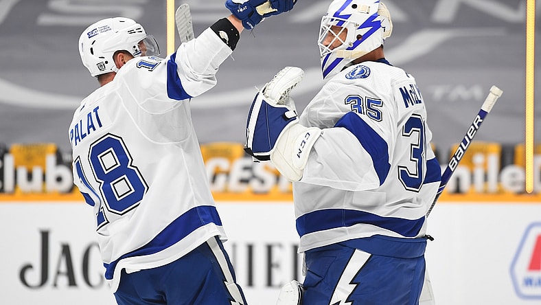Feb 8, 2021; Nashville, Tennessee, USA; Tampa Bay Lightning goaltender Curtis McElhinney (35) is congratulated by Tampa Bay Lightning left wing Ondrej Palat (18) after a win against the Nashville Predators at Bridgestone Arena. Mandatory Credit: Christopher Hanewinckel-USA TODAY Sports