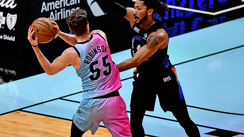 Feb 9, 2021; Miami, Florida, USA; Miami Heat guard Duncan Robinson (55) passes the ball around New York Knicks guard Derrick Rose (4) during the first half at American Airlines Arena. Mandatory Credit: Jasen Vinlove-USA TODAY Sports