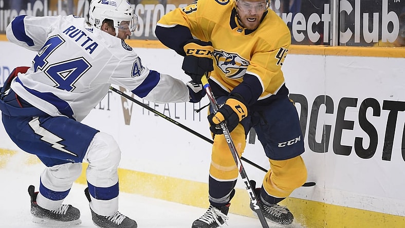 Feb 9, 2021; Nashville, Tennessee, USA;  Nashville Predators center Sean Malone (43) skates past Tampa Bay Lightning defenseman Jan Rutta (44) during the first period at Bridgestone Arena. Mandatory Credit: Steve Roberts-USA TODAY Sports