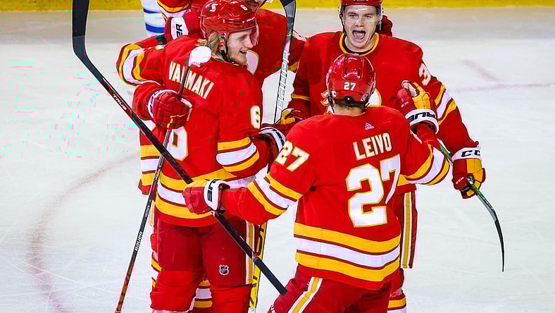 Feb 9, 2021; Calgary, Alberta, CAN; Calgary Flames defenseman Juuso Valimaki (6) celebrates his goal with teammates against the Winnipeg Jets during the second period at Scotiabank Saddledome. Mandatory Credit: Sergei Belski-USA TODAY Sports