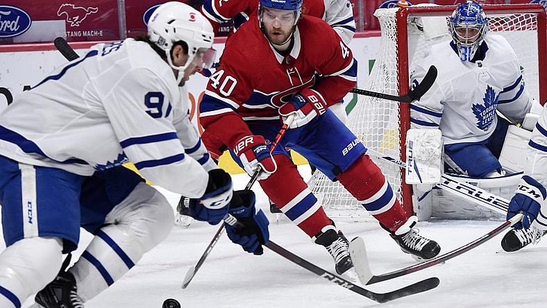 Feb 10, 2021; Montreal, Quebec, CAN; Montreal Canadiens forward Joel Armia (40) plays the puck and Toronto Maple Leafs forward John Tavares (91) defends during the first period at the Bell Centre. Mandatory Credit: Eric Bolte-USA TODAY Sports