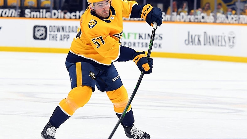 Feb 11, 2021; Nashville, Tennessee, USA; Nashville Predators defenseman Dante Fabbro (57) scores the game-winning goal late in the third period to beat the Detroit Red Wings at Bridgestone Arena. Mandatory Credit: Christopher Hanewinckel-USA TODAY Sports