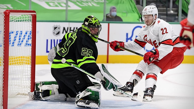 Feb 13, 2021; Dallas, Texas, USA; Dallas Stars goaltender Jake Oettinger (29) turns away a shot by Carolina Hurricanes defenseman Brett Pesce (22) during the first period at the American Airlines Center. Mandatory Credit: Jerome Miron-USA TODAY Sports