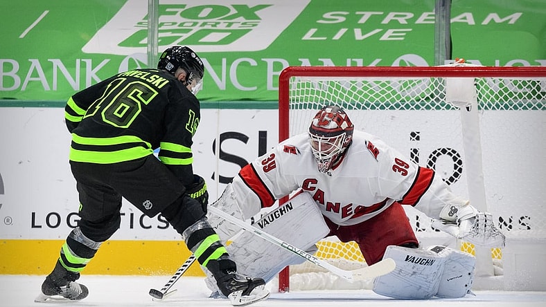 Feb 13, 2021; Dallas, Texas, USA; Carolina Hurricanes goaltender Alex Nedeljkovic (39) stops a shot by Dallas Stars center Joe Pavelski (16) during the overtime shootout at the American Airlines Center. Mandatory Credit: Jerome Miron-USA TODAY Sports
