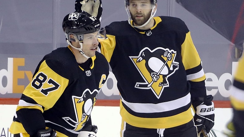 Feb 14, 2021; Pittsburgh, Pennsylvania, USA;  Pittsburgh Penguins right wing Bryan Rust (17) congratulates center Sidney Crosby (87) on his goal against the Washington Capitals during the third period at PPG Paints Arena. The Penguins won 6-3. Mandatory Credit: Charles LeClaire-USA TODAY Sports