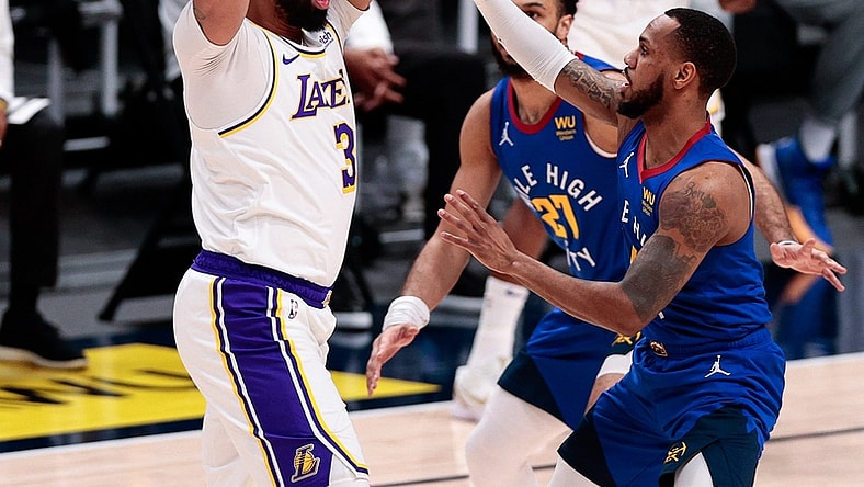 Feb 14, 2021; Denver, Colorado, USA; Los Angeles Lakers forward Anthony Davis (3) controls the ball under pressure from Denver Nuggets guard Monte Morris (11) and guard Jamal Murray (27) in the first quarter at Ball Arena. Mandatory Credit: Isaiah J. Downing-USA TODAY Sports