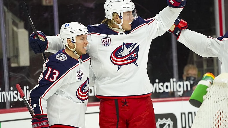 Feb 15, 2021; Raleigh, North Carolina, USA; Columbus Blue Jackets right wing Cam Atkinson (13) is congratulated by right wing Patrik Laine (29) after his goal against the Carolina Hurricanes the first period at PNC Arena. Mandatory Credit: James Guillory-USA TODAY Sports