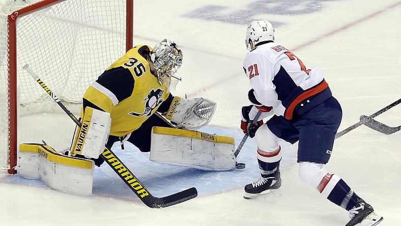 Feb 16, 2021; Pittsburgh, Pennsylvania, USA;  Pittsburgh Penguins goaltender Tristan Jarry (35) makes a save against Washington Capitals right wing Garnet Hathaway (21) during the first period at PPG Paints Arena. Mandatory Credit: Charles LeClaire-USA TODAY Sports
