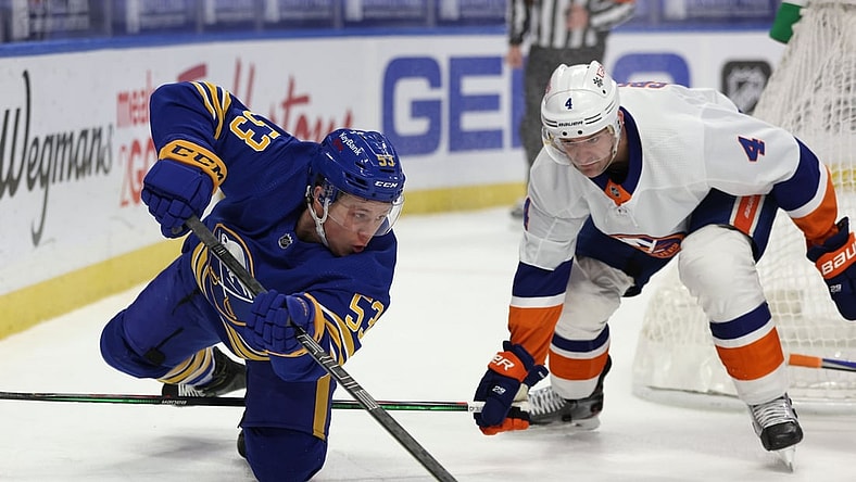 Feb 16, 2021; Buffalo, New York, USA;  New York Islanders defenseman Andy Greene (4) watches as Buffalo Sabres left wing Jeff Skinner (53) dives to make a pass during the second period at KeyBank Center. Mandatory Credit: Timothy T. Ludwig-USA TODAY Sports