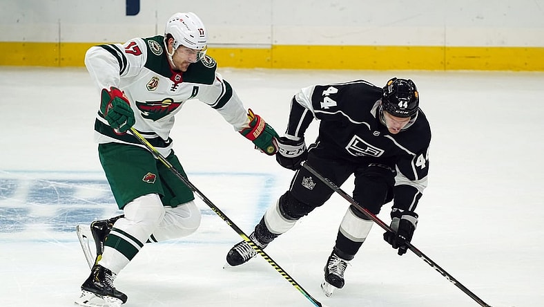 Feb 16, 2021; Los Angeles, California, USA; Minnesota Wild left wing Marcus Foligno (17) and LA Kings defenseman Mikey Anderson (44) battle for the puck in the first period at Staples Center. Mandatory Credit: Kirby Lee-USA TODAY Sports