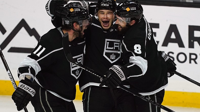 Feb 16, 2021; Los Angeles, California, USA; LA Kings right wing Dustin Brown (23) celebrates with center Anze Kopitar (11) and defenseman Drew Doughty (8) after scoring a goal against the Minnesota Wild in the third period at Staples Center. Mandatory Credit: Kirby Lee-USA TODAY Sports