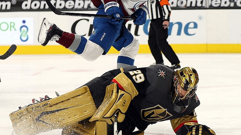 Feb 16, 2021; Las Vegas, Nevada, USA; Colorado Avalanche center Jayson Megna (12) skates over Vegas Golden Knights goalie Marc-Andre Fleury (29) during the third period at T-Mobile Arena. Mandatory Credit:  Isaac Brekken/Pool Photos-USA TODAY Sports