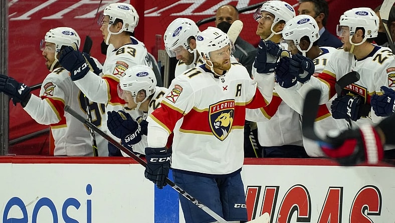 Feb 17, 2021; Raleigh, North Carolina, USA;  Florida Panthers left wing Jonathan Huberdeau (11) is congratulated after scoring a goal against the Carolina Hurricanes during the second period at PNC Arena. Mandatory Credit: James Guillory-USA TODAY Sports