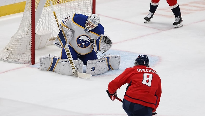 Feb 18, 2021; Washington, District of Columbia, USA; Buffalo Sabres goaltender Linus Ullmark (35) makes a save on Washington Capitals left wing Alex Ovechkin (8) in the first period at Capital One Arena. Mandatory Credit: Geoff Burke-USA TODAY Sports