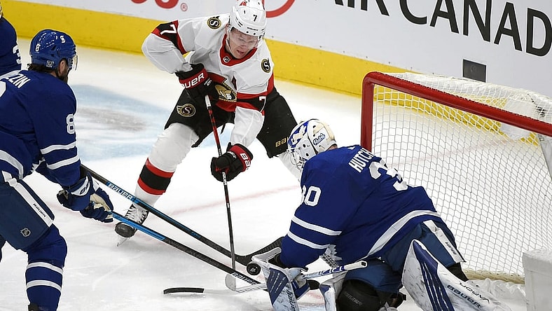 Feb 18, 2021; Toronto, Ontario, CAN;  Ottawa Senators forward Brady Tkachuk (7) shoots the puck as Toronto Maple Leafs goalie Michael Hutchinson (30) defends in the first period at Scotiabank Arena. Mandatory Credit: Dan Hamilton-USA TODAY Sports