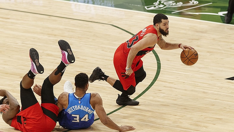 Feb 18, 2021; Milwaukee, Wisconsin, USA; Toronto Raptors guard Fred Vanvleet (23) dribbles the ball around Milwaukee Bucks forward Giannis Antetokounmpo (34) during the third quarter at Fiserv Forum. Mandatory Credit: Jeff Hanisch-USA TODAY Sports
