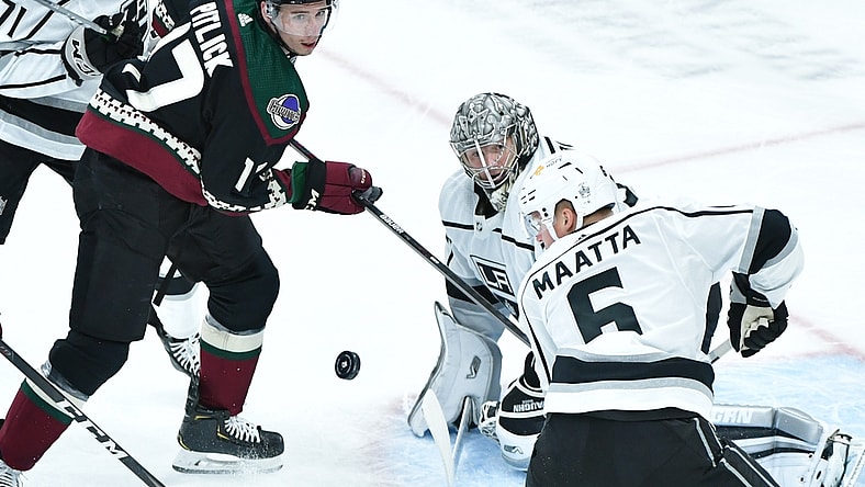 Feb 18, 2021; Glendale, Arizona, USA; Arizona Coyotes center Tyler Pitlick (17), z5 and goaltender Jonathan Quick (32) watch a rebounding puck during the first period  at Gila River Arena. Mandatory Credit: Matt Kartozian-USA TODAY Sports