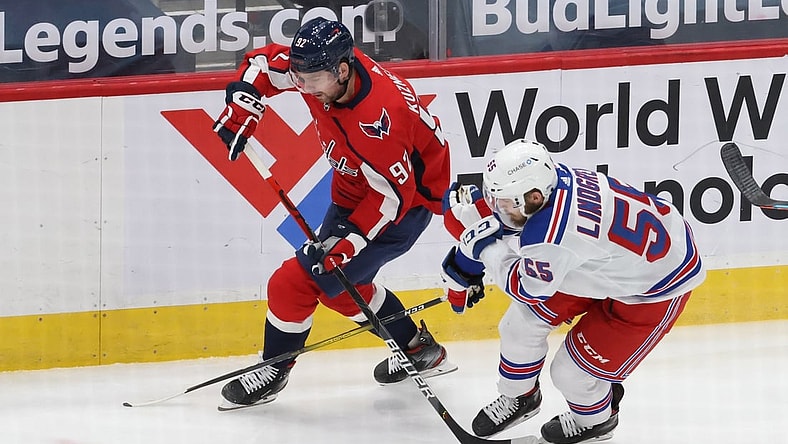 Feb 20, 2021; Washington, District of Columbia, USA; Washington Capitals center Evgeny Kuznetsov (92). Skates with the puck as New York Rangers defenseman Ryan Lindgren (55) defends in the first period at Capital One Arena. Mandatory Credit: Geoff Burke-USA TODAY Sports
