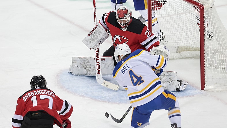 Feb 20, 2021; Newark, New Jersey, USA; Buffalo Sabres left wing Taylor Hall (4) shoots the puck at New Jersey Devils goaltender Mackenzie Blackwood (29) during the first period at Prudential Center. Mandatory Credit: Vincent Carchietta-USA TODAY Sports
