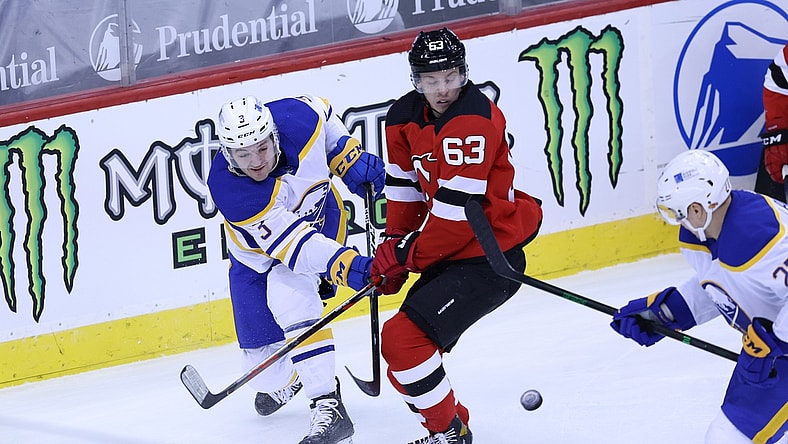 Feb 20, 2021; Newark, New Jersey, USA; Buffalo Sabres defenseman William Borgen (3) passes the puck against New Jersey Devils left wing Jesper Bratt (63) during the first period at Prudential Center. Mandatory Credit: Vincent Carchietta-USA TODAY Sports