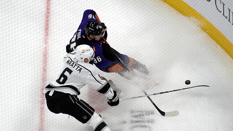 Feb 20, 2021; Glendale, Arizona, USA; Los Angeles Kings defenseman Olli Maatta (6) and Arizona Coyotes right wing Christian Fischer (36) battle for the puck during the first period at Gila River Arena. Mandatory Credit: Joe Camporeale-USA TODAY Sports