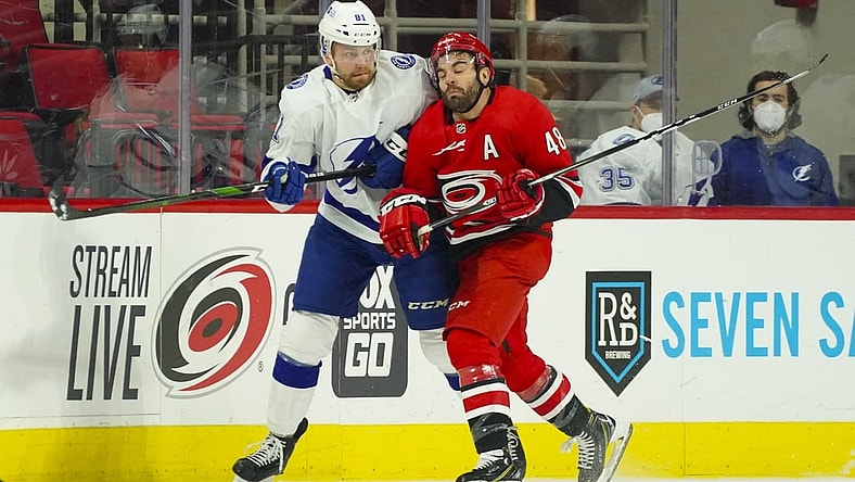 Feb 20, 2021; Raleigh, North Carolina, USA;  Carolina Hurricanes left wing Jordan Martinook (48) checks Tampa Bay Lightning defenseman Erik Cernak (81) during the first period at PNC Arena. Mandatory Credit: James Guillory-USA TODAY Sports