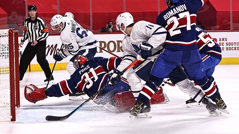 Feb 20, 2021; Montreal, Quebec, CAN; Montreal Canadiens goaltender Carey Price (31) makes a save against Toronto Maple Leafs right wing Ilya Mikheyev (65) and left wing Zach Hyman (11) and defenseman Alexander Romanov (27) during the first period at Bell Centre. Mandatory Credit: Jean-Yves Ahern-USA TODAY Sports