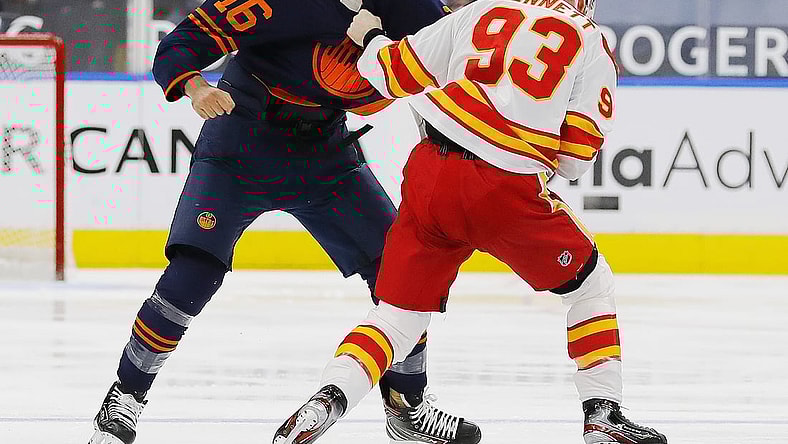 Feb 20, 2021; Edmonton, Alberta, CAN; Edmonton Oilers forward Jujhar Khaira (16) fights Calgary Flames forward Sam Bennett (93) during the first period  at Rogers Place. Mandatory Credit: Perry Nelson-USA TODAY Sports