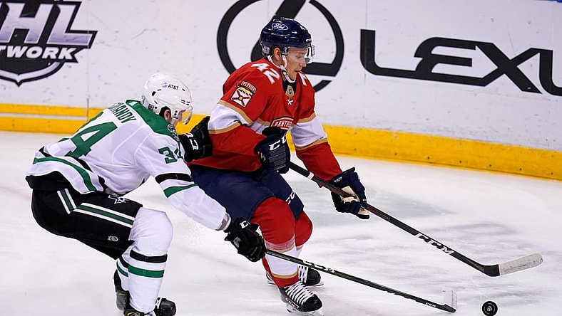 Feb 22, 2021; Sunrise, Florida, USA; Florida Panthers defenseman Gustav Forsling (42) controls the puck away from Dallas Stars right wing Denis Gurianov (34) during the the first period at BB&T Center. Mandatory Credit: Jasen Vinlove-USA TODAY Sports