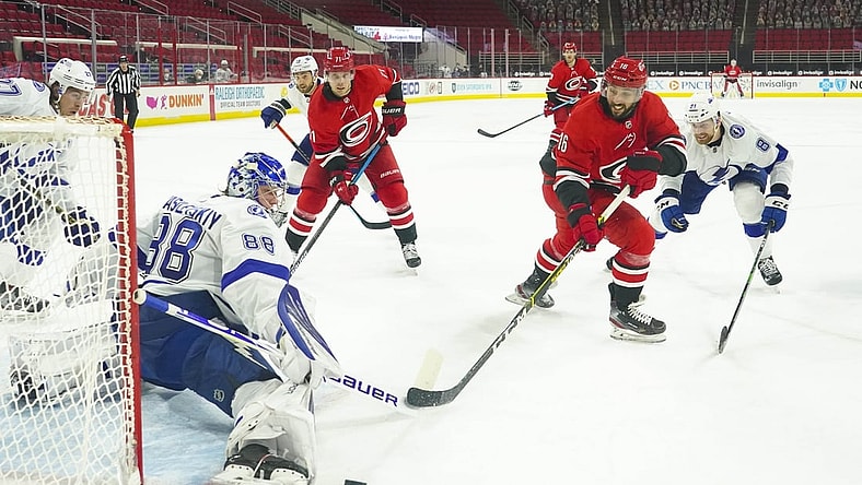 Feb 22, 2021; Raleigh, North Carolina, USA;  Tampa Bay Lightning goaltender Andrei Vasilevskiy (88) stops the shot against Carolina Hurricanes center Vincent Trocheck (16) at PNC Arena. Mandatory Credit: James Guillory-USA TODAY Sports