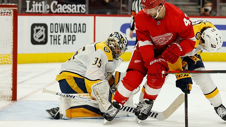Feb 23, 2021; Detroit, Michigan, USA;  Nashville Predators goaltender Pekka Rinne (35) makes the save ion Detroit Red Wings left wing Darren Helm (43) in the second period  at Little Caesars Arena. Mandatory Credit: Rick Osentoski-USA TODAY Sports