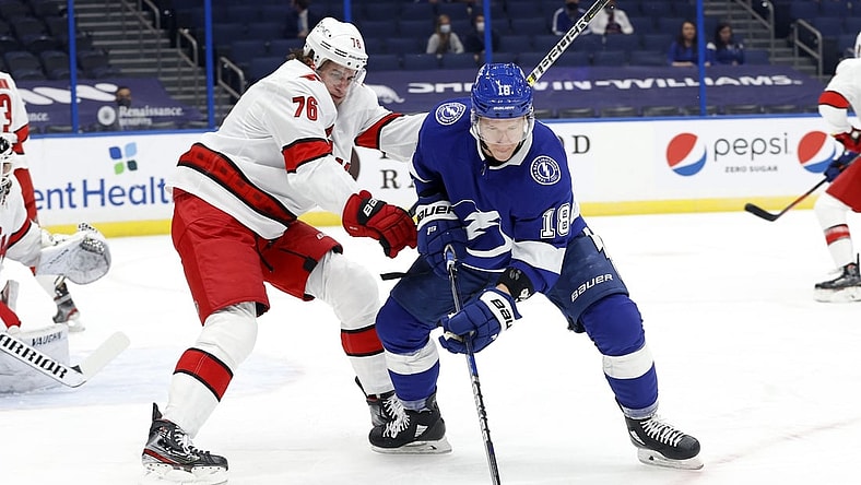 Feb 24, 2021; Tampa, Florida, USA; Tampa Bay Lightning left wing Ondrej Palat (18) skates with the  puck as Carolina Hurricanes defenseman Brady Skjei (76) defends during the first period at Amalie Arena. Mandatory Credit: Kim Klement-USA TODAY Sports