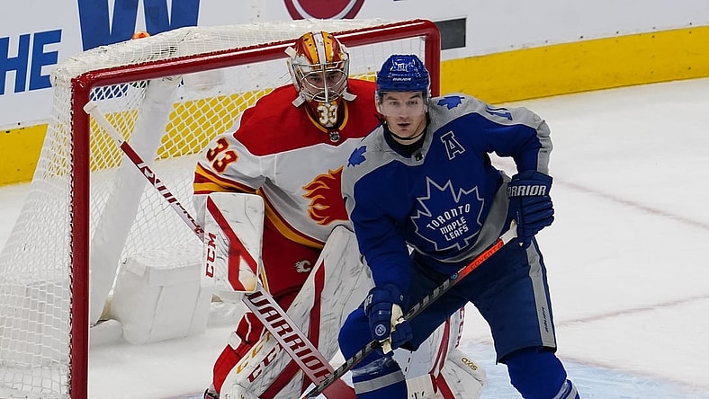 Feb 24, 2021; Toronto, Ontario, CAN; Toronto Maple Leafs forward Zach Hyman (11) screens Calgary Flames goaltender David Rittich (33) during the first period at Scotiabank Arena. Mandatory Credit: John E. Sokolowski-USA TODAY Sports
