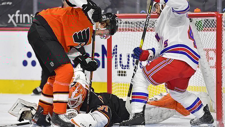 Feb 24, 2021; Philadelphia, Pennsylvania, USA; Philadelphia Flyers goaltender Brian Elliott (37) covers the puck with help from defenseman Travis Sanheim (6) against New York Rangers center Colin Blackwell (43) during the first period at Wells Fargo Center. Mandatory Credit: Eric Hartline-USA TODAY Sports