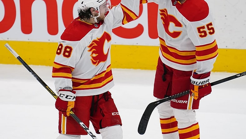 Feb 24, 2021; Toronto, Ontario, CAN; Calgary Flames forward Andrew Mangiapane (88) celebrates his goal against the Toronto Maple Leafs with Calgary Flames defenseman Noah Hanifin (55) during the third period at Scotiabank Arena. Mandatory Credit: John E. Sokolowski-USA TODAY Sports