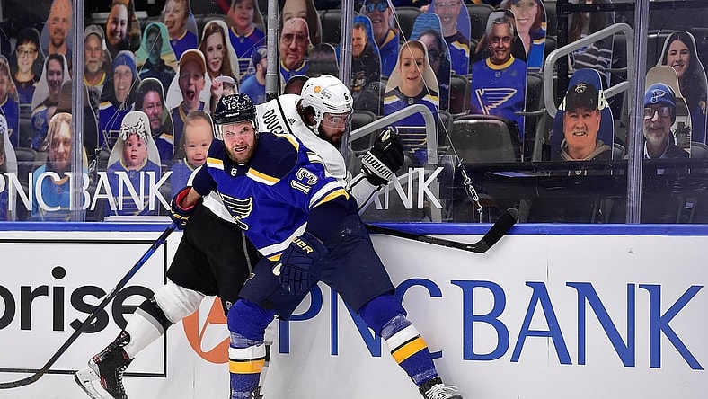 Feb 24, 2021; St. Louis, Missouri, USA;  St. Louis Blues left wing Kyle Clifford (13) checks Los Angeles Kings defenseman Drew Doughty (8) during the first period at Enterprise Center. Mandatory Credit: Jeff Curry-USA TODAY Sports