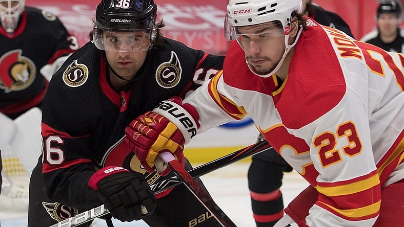 Feb 25, 2021; Ottawa, Ontario, CAN; Ottawa Senators center Colin White (36) faces off against Calgary Flames center Sean Monahan (23) in the first period at the Canadian Tire Centre. Mandatory Credit: Marc DesRosiers-USA TODAY Sports
