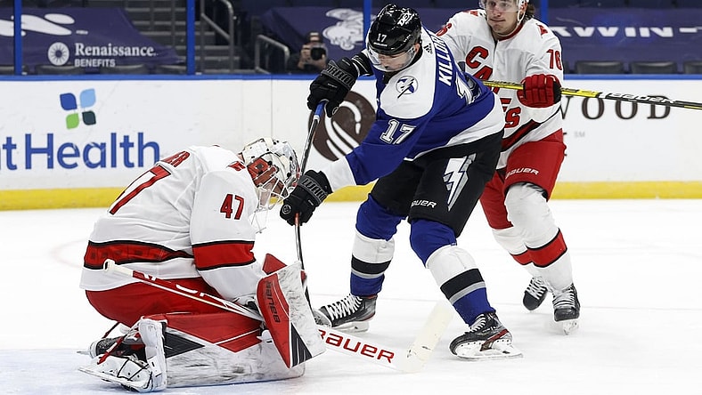 Feb 25, 2021; Tampa, Florida, USA; Tampa Bay Lightning left wing Alex Killorn (17) shoots as Carolina Hurricanes goaltender James Reimer (47) makes a save during the first period at Amalie Arena. Mandatory Credit: Kim Klement-USA TODAY Sports