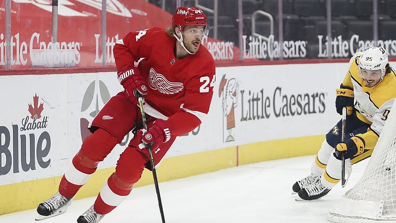Feb 25, 2021; Detroit, Michigan, USA; Detroit Red Wings defenseman Jon Merrill (24) skates away from Nashville Predators center Matt Duchene (95) during the first period at Little Caesars Arena. Mandatory Credit: Raj Mehta-USA TODAY Sports