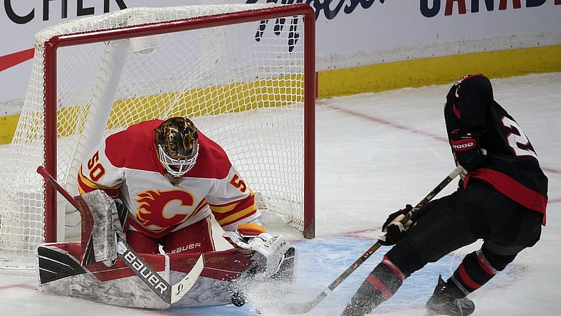 Feb 25, 2021; Ottawa, Ontario, CAN; Ottawa Senators right wing Connor Brown (28) tries to recover the puck on a rebound from Calgary Flames goalie Artyom Zagidulin (50) in the third period at the Canadian Tire Centre. Mandatory Credit: Marc DesRosiers-USA TODAY Sports