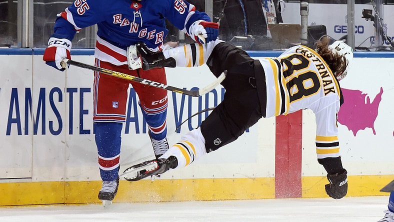 Feb 26, 2021; New York, New York, USA; Ryan Lindgren #55 of the New York Rangers checks David Pastrnak #88 of the Boston Bruins during the first period at Madison Square Garden. Mandatory Credit:  POOL PHOTOS-USA TODAY Sports