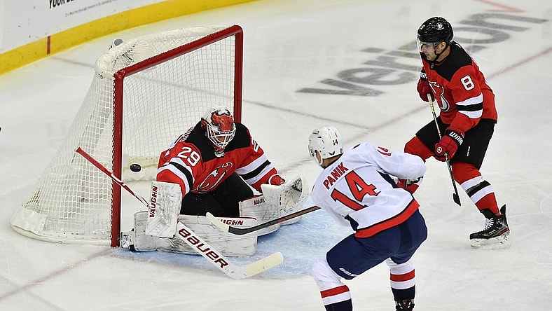 Feb 27, 2021; Newark, New Jersey, USA; New Jersey Devils goalie Mackenzie Blackwood (29) blocks a shot by Washington Capitals right wing Richard Panik (14) during the second period at Prudential Center. Mandatory Credit: Catalina Fragoso-USA TODAY Sports