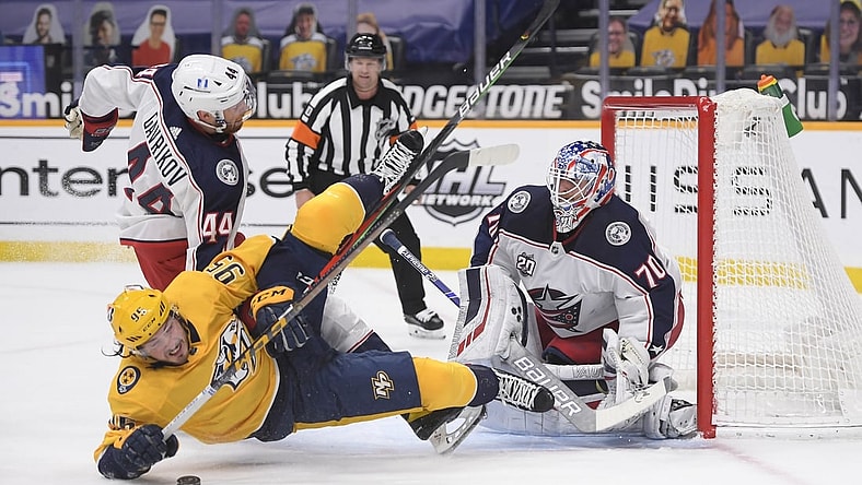 Feb 27, 2021; Nashville, Tennessee, USA;  Columbus Blue Jackets goaltender Joonas Korpisalo (70) blocks a shot by Nashville Predators center Matt Duchene (95) during the first period at Bridgestone Arena. Mandatory Credit: Steve Roberts-USA TODAY Sports
