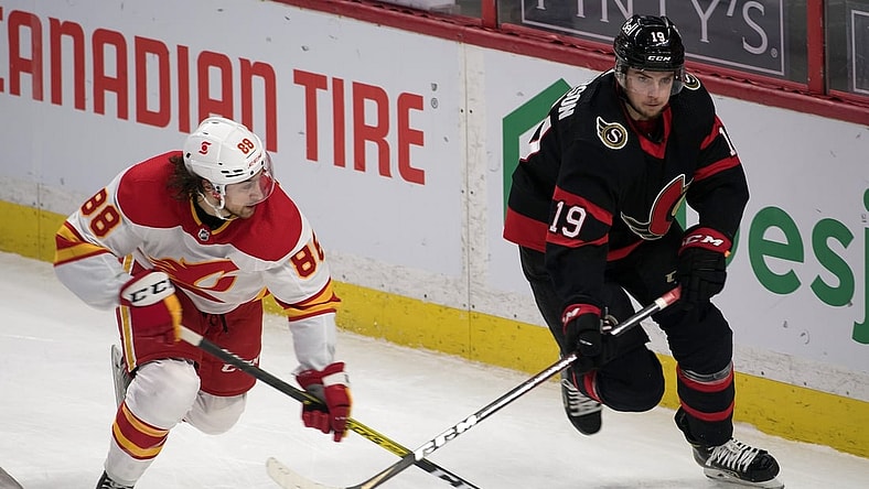 Feb 27, 2021; Ottawa, Ontario, CAN; Calgary Flamesleft wing Andrew Mangiapane (88) chases Ottawa Senators right wing Drake Batherson (19) in the third period at the Canadian Tire Centre. Mandatory Credit: Marc DesRosiers-USA TODAY Sports