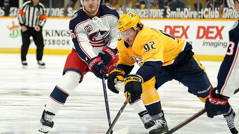 Feb 27, 2021; Nashville, Tennessee, USA;  Nashville Predators center Ryan Johansen (92) and Columbus Blue Jackets center Jack Roslovic (96) fight for the puck during the third period at Bridgestone Arena. Mandatory Credit: Steve Roberts-USA TODAY Sports
