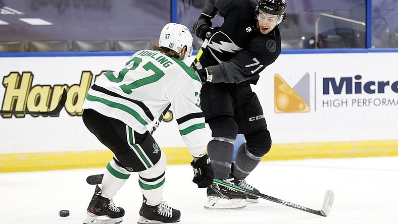 Feb 27, 2021; Tampa, Florida, USA; Tampa Bay Lightning center Anthony Cirelli (71) shoots as Dallas Stars center Justin Dowling (37) defend during the first period at Amalie Arena. Mandatory Credit: Ki Klement-USA TODAY Sports