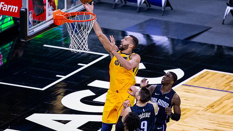 Feb 27, 2021; Orlando, Florida, USA; Utah Jazz center Rudy Gobert (27) attempts a layup during the first quarter of a game between the Orlando Magic and the Utah Jazz at Amway Center. Mandatory Credit: Mary Holt-USA TODAY Sports