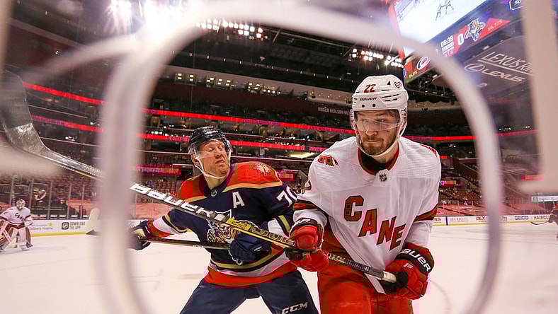 Feb 27, 2021; Sunrise, Florida, USA; Carolina Hurricanes defenseman Brett Pesce (22) gets push against the glass by Florida Panthers right wing Patric Hornqvist (70) during the second period at BB&T Center. Mandatory Credit: Sam Navarro-USA TODAY Sports
