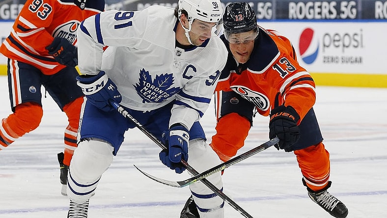 Feb 27, 2021; Edmonton, Alberta, CAN; Edmonton Oilers forward Jesse Puljujarvi (13) chases Toronto Maple Leafs forward John Tavares (91) during the second period at Rogers Place. Mandatory Credit: Perry Nelson-USA TODAY Sports