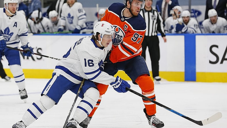 Feb 27, 2021; Edmonton, Alberta, CAN; Toronto Maple Leafs forward Mitch Marner (16) and Edmonton Oilers forward Connor McDavid (97) battle for position during the second period at Rogers Place. Mandatory Credit: Perry Nelson-USA TODAY Sports